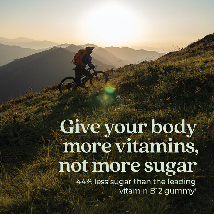 At sunrise, a person rides a mountain bike up a grassy slope. Text: Support healthy nerve function with New Chapter Cellular Energy Vitamin B12 + Gummies—44% less sugar than leading vitamin B12 gummies, plus more vitamins and delicious raspberry flavor.