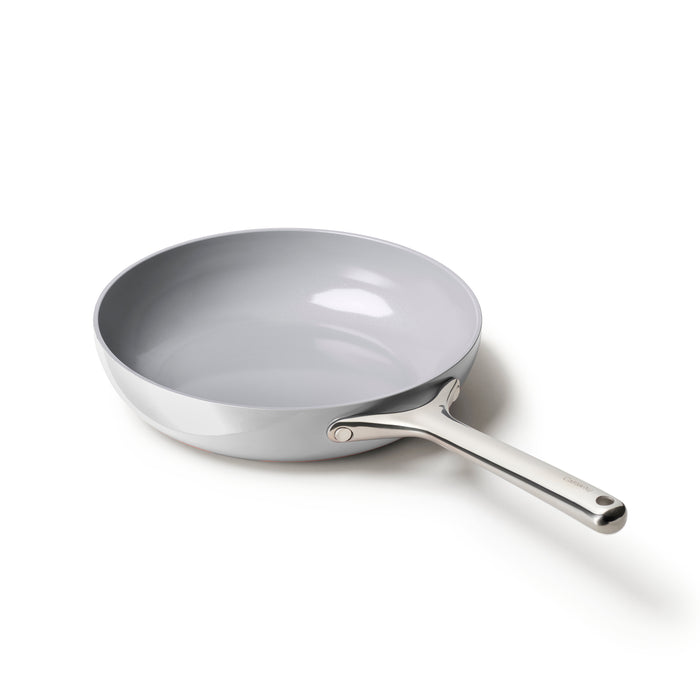 The Caraway Ceramic Fry Pan, 10.5, in silver, features a naturally non-stick ceramic-coated interior and sleek design, displayed against a white background. Its long handle complements the smooth, shiny surface that perfectly reflects light.