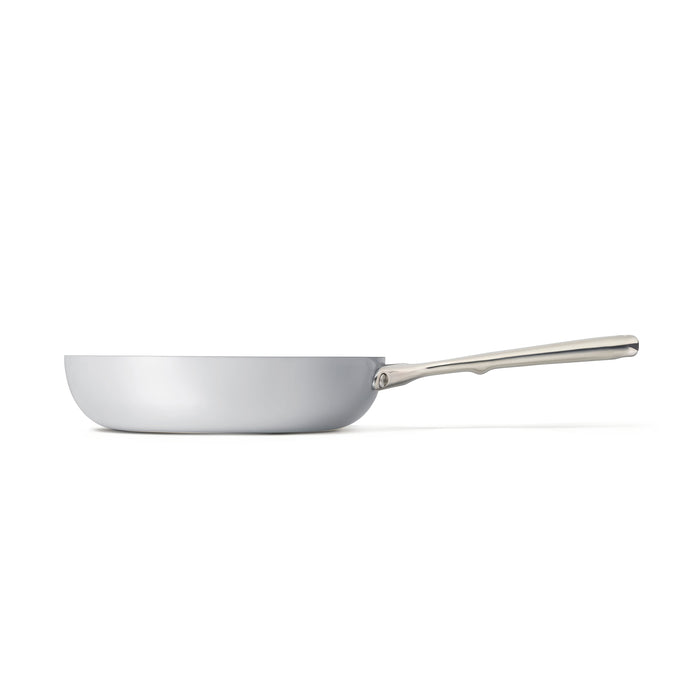 The side view of the Caraway Ceramic Fry Pan, 10.5 showcases its sleek, modern design and long, robust handle. Its naturally non-stick ceramic-coated interior makes this stainless steel fry pan ideal for diverse cooking tasks, all set against a plain white background.