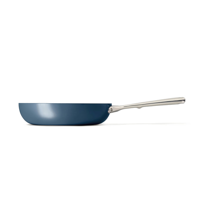 Side view of a Caraway Ceramic Fry Pan, 10.5, in blue with a ceramic-coated interior and shiny silver handle, photographed on a white background.