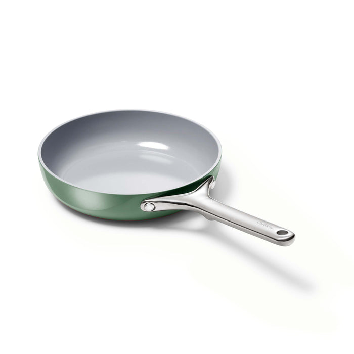 The Caraway Ceramic Fry Pan, 8, features a green and white non-stick surface with a silver handle, set against a white background.