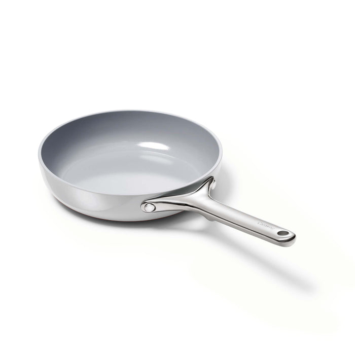 A Caraway Ceramic Fry Pan, 8, features a silver non-stick surface with a smooth, wide cooking area and a long handle, positioned at an angle on a plain white background.