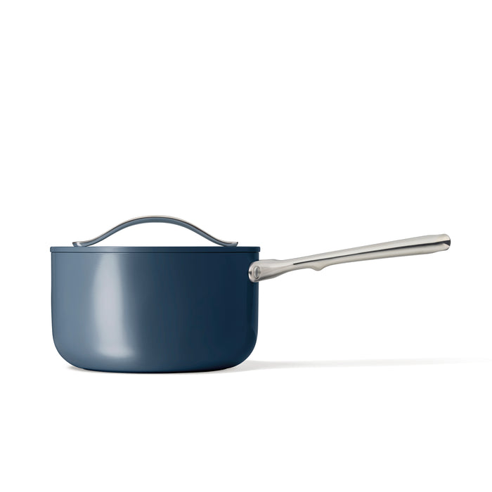 A Caraway Ceramic Sauce Pan, 3 qt, with a long metal handle and matching lid, appears against a white background. This non-toxic pot has a sleek design, glossy finish, and ceramic-coated interior for effortless cooking.