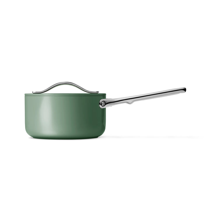 The Caraway Ceramic Sauce Pan with Lid (1.75 qt) features a green design with a long silver handle and matching lid, non-toxic coating for healthy cooking, and non-stick surface for easy use, all showcased on a white background.
