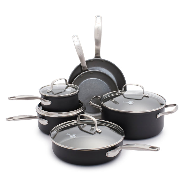 The GreenPan Chatham Ceramic, Non-Stick Cookware Set in sleek black includes two frying pans, two PFAS-free saucepans with glass lids, and a large pot. The pots feature a metal brushed finish with Thermolon ceramic nonstick surfaces and are displayed neatly on a white surface.