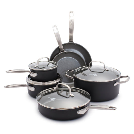 The GreenPan Chatham Ceramic, Non-Stick Cookware Set in sleek black includes two frying pans, two PFAS-free saucepans with glass lids, and a large pot. The pots feature a metal brushed finish with Thermolon ceramic nonstick surfaces and are displayed neatly on a white surface.