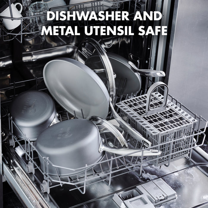 Open dishwasher filled with various cookware, including the GreenPan Chatham 12" Open Frypan. The text over the image reads: “DISHWASHER AND METAL UTENSIL SAFE.”.