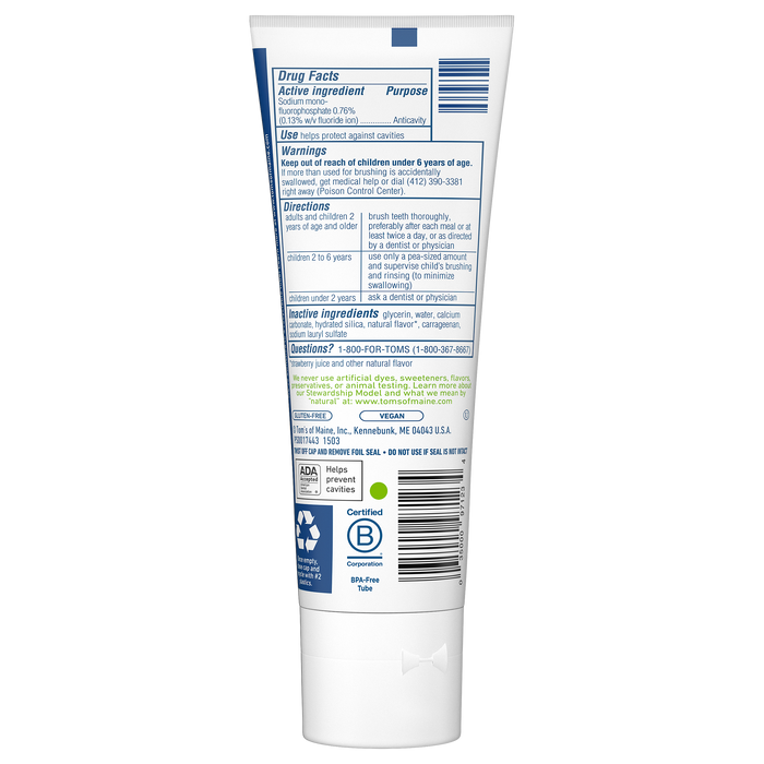 The image displays the back of a white tube of Toms of Maine Childrens Silly Strawberry Fluoride Toothpaste with blue accents. The label contains drug facts, directions, warnings, and shows symbols for cruelty-free and recyclable. The ADA seal is also visible.