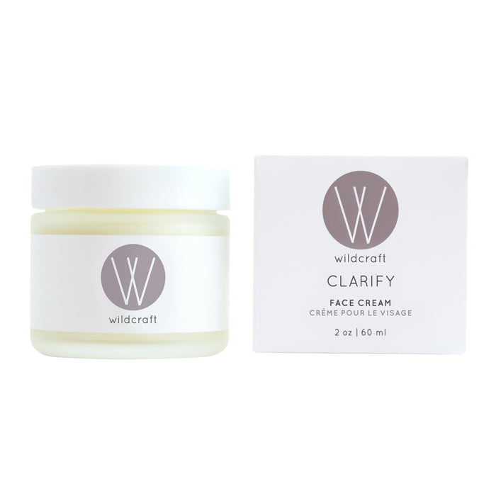 A 2 oz (60 ml) Wildcraft Clarify Face Cream for sensitive skin, adorned with the Wildcraft logo. The white jar has a gray lid, and the box elegantly displays the product name in gray lettering.