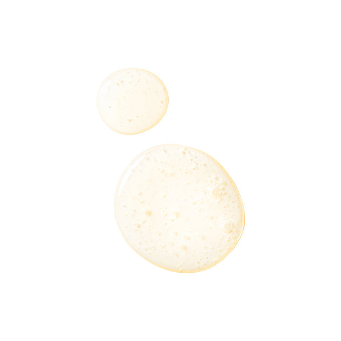 Two translucent beige drops of Tree To Tub Clarifying Shampoo for Oily Hair & Sensitive Scalp rest on a white background. The larger drop, filled with bubbles, contrasts with the smaller, smooth one.