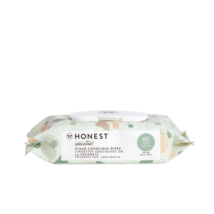 A pack of Clean Conscious™ Wipes by The Honest Company. The pale green packaging features abstract peach and cream shapes, containing 60 fragrance-free, hypoallergenic wipes for sensitive skin with a convenient white plastic dispenser lid.