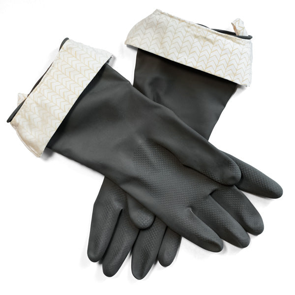On a white surface lies a pair of Grove Co. Cleaning Gloves in dark gray, featuring durable latex with textured grips and lightly patterned cuffs. The sleek design makes them ideal for household tasks such as dishwashing and other chores.