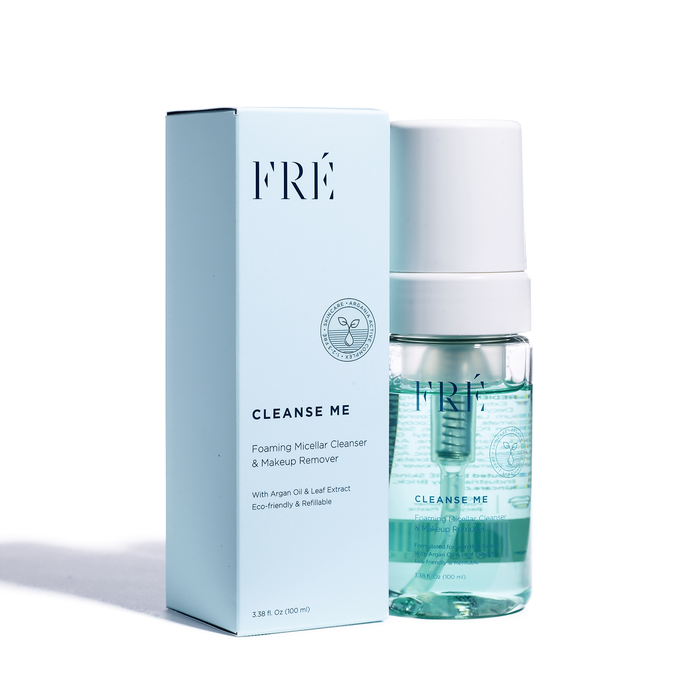 A light blue rectangular box labeled FRÉ Cleanse Me is next to a clear bottle of CLEANSE ME Foaming Micellar Water from FRÉ Skincare. The turquoise bottle, with a white top, serves as an effective facial cleanser. Both items feature text and the brand logo, casting shadows on the white background.