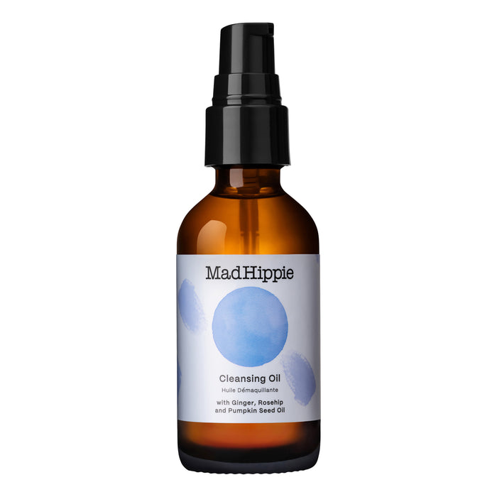 The Mad Hippie Cleansing Oil comes in a brown glass bottle with a black pump and blue circular designs, offering a refreshing cleanse using organic ingredients such as ginger, rosehip, and pumpkin seed oil.