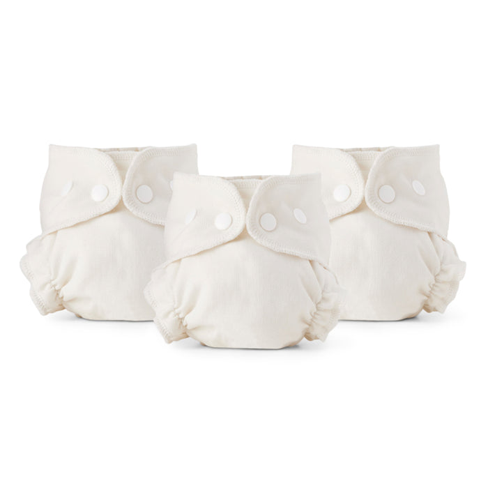 Three Esembly Baby Cloth Diaper Inners, size 1 and ivory in color, made from 100% OEKO-TEX certified unbleached organic cotton, are lined up. They feature adjustable snap buttons and elastic leg openings for a snug fit, designed to be blowout-proof with a soft and absorbent material.