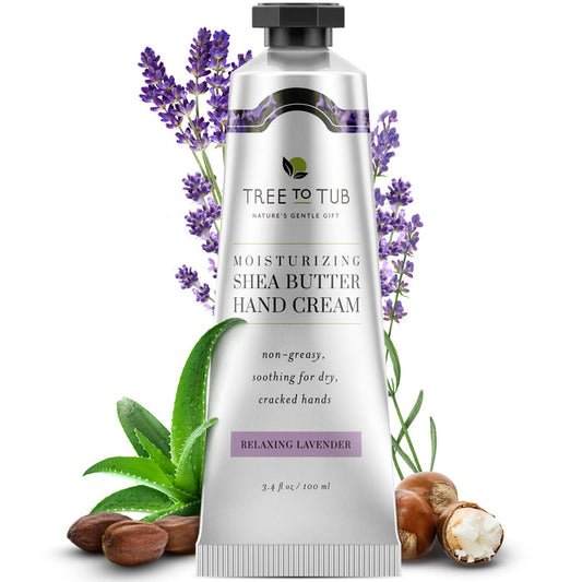 A silver tube of Tree To Tub Cocoa & Shea Butter Anti-Aging Hand Cream for Dry Hands stands upright, surrounded by sprigs of lavender, green aloe vera leaves, and shea nuts, enhancing the natural and soothing essence of this luxurious lotion.