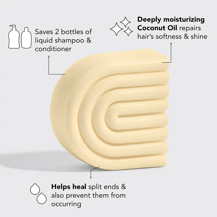 An image of a creamy yellow bar of solid shampoo. Text on the image highlights its benefits: it saves two bottles of liquid shampoo and conditioner, deeply moisturizes with coconut oil to repair hair's softness and shine, and helps heal and prevent split ends.