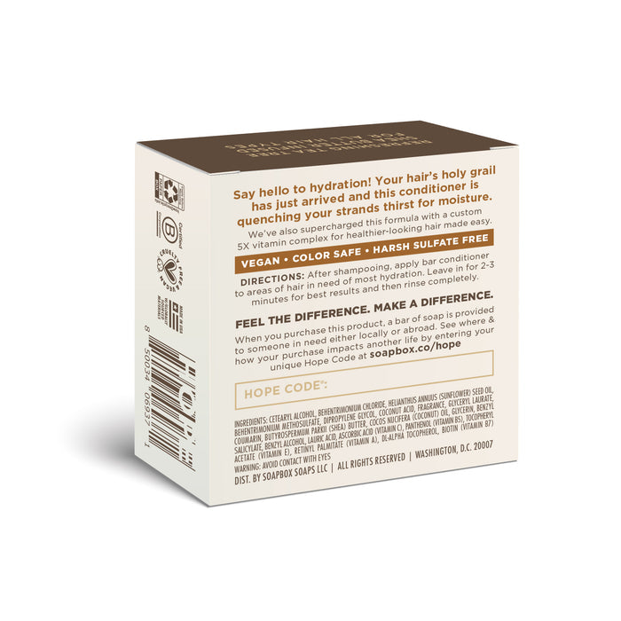 A cardboard box holds the Soapbox Coconut Oil Moisturizing Conditioner Bar, enriched with a vitamin complex. Its packaging boasts benefits like being vegan, color-safe, and free of harsh sulfates. A hope code and a website link are included for more details.