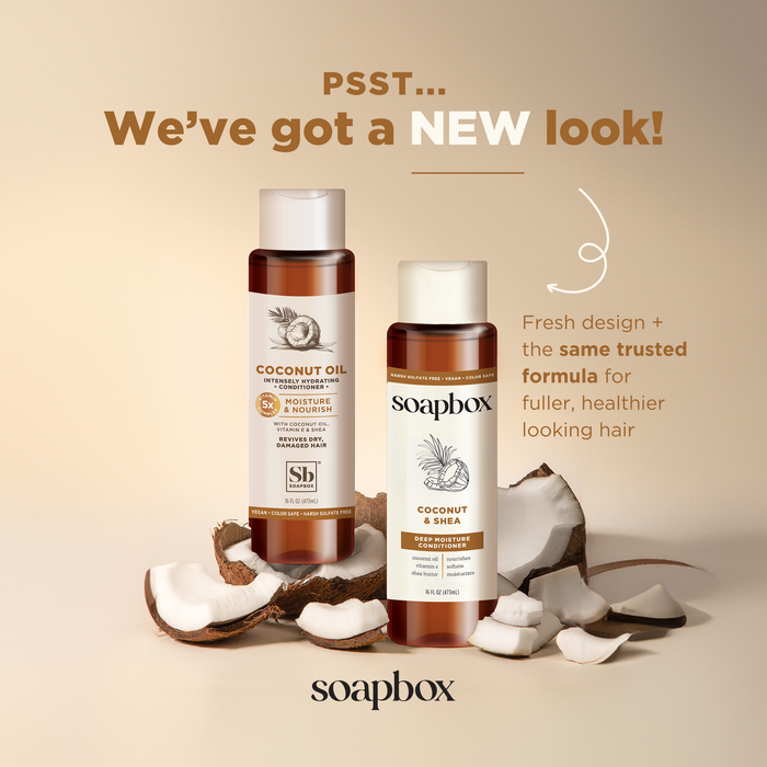 Two brown Soapbox Coconut & Shea Deep Moisture Conditioner bottles are shown with coconut pieces. Text says: PSST... Weve got a NEW look! Fresh design + the same trusted formula with coconut oil for fuller, healthier looking hair. The background is a soft beige.