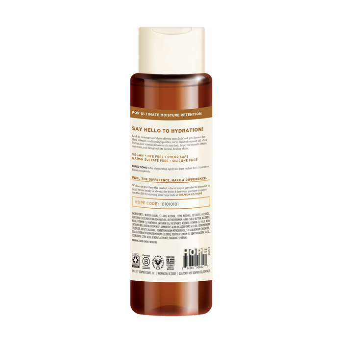 The Soapbox Coconut & Shea Deep Moisture Conditioner is in a translucent bottle with a white cap and features the label Say Hello to Hydration. Its vegan, dye-free, color-safe, and silicone-free, enriched with coconut oil. Ingredients and details are printed on the label.