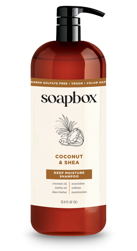 Soapboxs Coconut & Shea Deep Moisture Shampoo 1L features a pump dispenser and is labeled Marsh Sulfate Free, Vegan, and Color Safe. It includes coconut oil, jojoba oil, shea butter, and a nourishing vitamin complex.