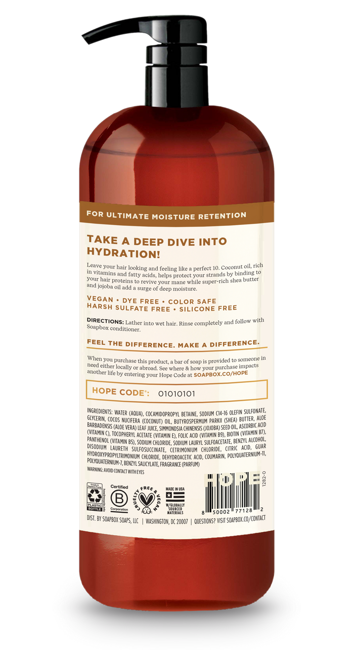 A tall, red bottle with a black pump contains Soapboxs Coconut & Shea Deep Moisture Shampoo. The label says Take a Deep Dive into Hydration! highlighting its vitamin complex, vegan, dye-free, color-safe features. It’s infused with coconut oil and lists ingredients and a HOPE code.