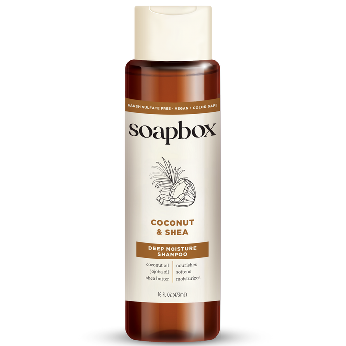 Soapboxs Coconut & Shea Deep Moisture Shampoo, in a 16 fl oz bottle featuring a coconut-themed label, is sulfate-free, vegan, and color-safe. Enriched with coconut oil, jojoba oil, and a vitamin complex for nourishment.