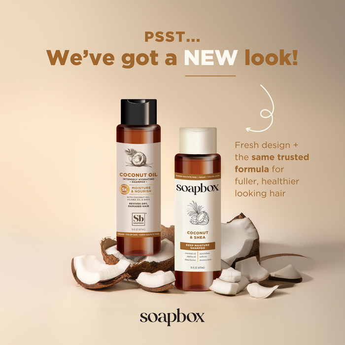 Two bottles of Soapboxs Coconut & Shea Deep Moisture Shampoo are displayed among broken coconut pieces. The text says, PSST... We’ve got a NEW look! Fresh design + same trusted formula with nourishing coconut oil for fuller, healthier-looking hair.