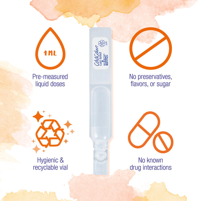 An image of a ColdCalm single-use vial is surrounded by icons and text highlights. Left to right: a 1mL drop icon with "Pre-measured liquid doses," a no symbol over a bottle with "No preservatives, flavors, or sugar," a recycle icon with "Hygienic & recyclable vial," and a pill icon with "No known drug interactions." The background features watercolor splashes.
