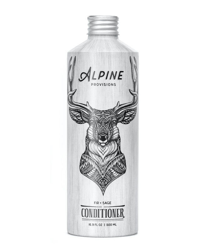 The Alpine Provisions Conditioner, with its tall silver bottle, showcases a detailed black deer head illustration. This 16.9 fl oz / 500 mL moisturizing essential offers a natural Fir + Sage scent.
