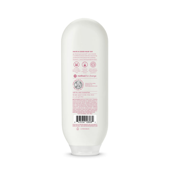 Back view of a white recycled plastic conditioner bottle by method, featuring pink text with product details like ingredients and a barcode at the bottom, rounded top, and flat cap for upright standing.