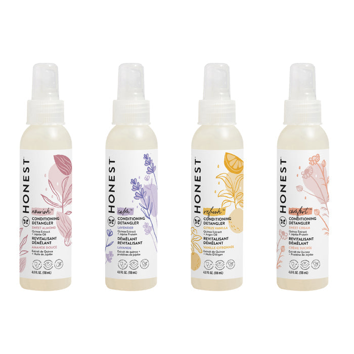 Four bottles of The Honest Company Conditioning Detangler are lined up, each with distinct colored floral designs on white labels. With unique formulas for silky strands, Honest appears vertically aligned on the left side of every bottle.