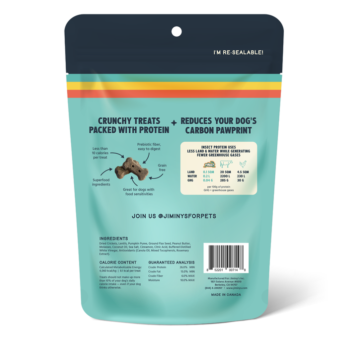Back of resealable Jiminy's Crunchy Original Cricket Dog Treat bag with text on protein-packed, grain-free treats made with cricket protein. Includes icons, greenhouse gas chart, ingredients, nutrition facts, barcode & social media info.