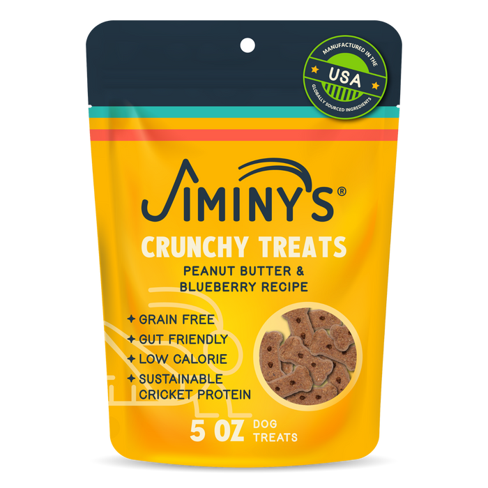 A yellow and orange pouch labeled Jiminy's Crunchy Peanut Butter & Blueberry Cricket Dog Treat, featuring grain-free, gut-friendly, low-calorie, sustainable dog treats made in the USA; 5 oz.