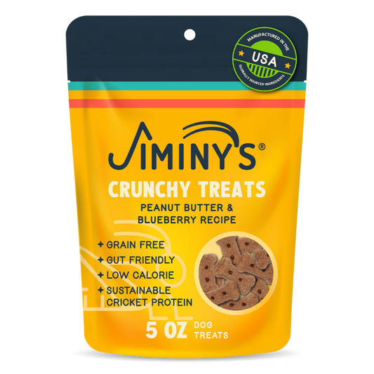 A yellow and orange pouch labeled Jiminy's Crunchy Peanut Butter & Blueberry Cricket Dog Treat, featuring grain-free, gut-friendly, low-calorie, sustainable dog treats made in the USA; 5 oz.