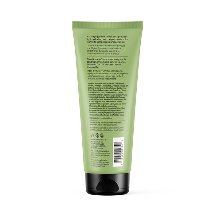 A green squeeze tube with a black cap, shown from the back. The label features Acures Curiously Clarifying Conditioner details, directions, ingredients, and recycling symbols in small black text.