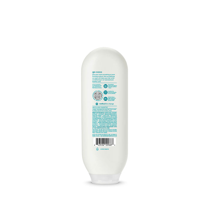 A white bottle of methods Curl Defining Co-Wash is shown from the back, displaying a label with instructions, ingredients, and logos. Infused with coconut milk, this cruelty-free product features a rounded cap and flat base for upright display.