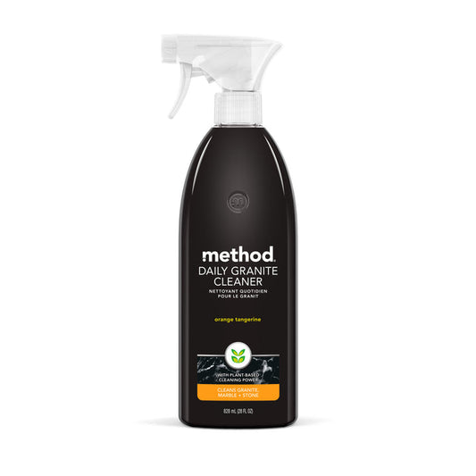 The Method Daily Granite Cleaner is a black spray bottle with a white nozzle, perfect for marble and granite surfaces. Its label shows the brand name method and describes it as orange tangerine for cleaning natural stone, with an 828 ml (28 fl oz) capacity.