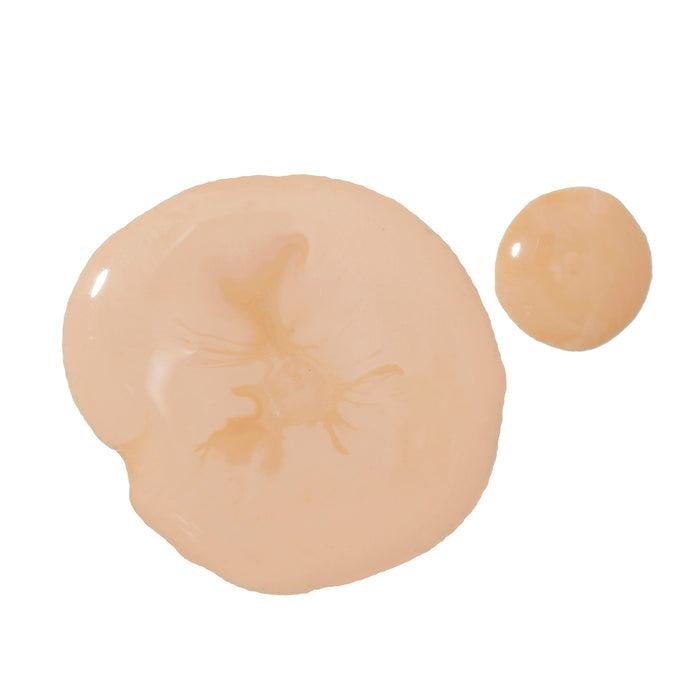 On a white background, two beige blobs of Indie Lees Daily SPF Primer appear. One larger, smooth and unevenly shaped; the other smaller and circular. Their glossy texture hints at a skincare finale enhanced with niacinamide for a luminous finish.