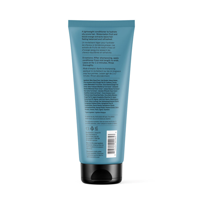 A blue tube of Acure Daily Workout Conditioner with a black cap, shown from the back. The label lists directions for daily use, ingredients such as watermelon seed extract, product info, and a barcode in white text.