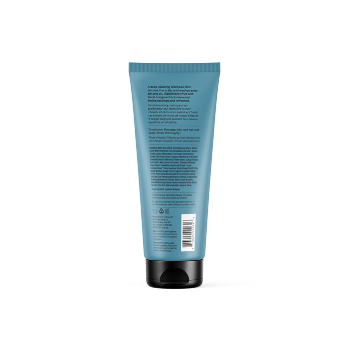 A teal plastic tube of Acure Daily Workout Shampoo with a black flip-top cap is shown from the back. White text displays product info, instructions, symbols, and a barcode. The packaging highlights the TerraCycle recycling program on white.