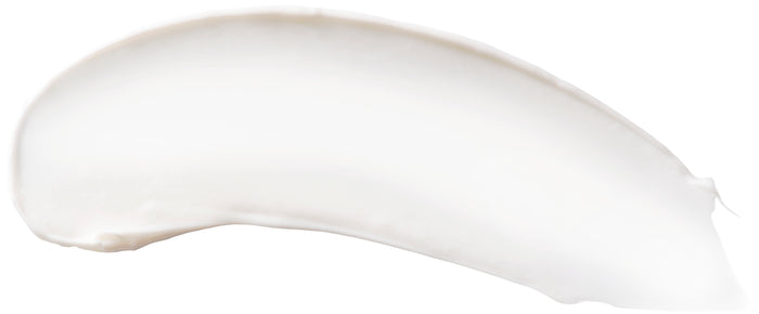 A smooth, white, creamy smear on a white background likely depicts Burts Bees Deep Cleansing Cream, a moisturizer infused with chamomile and aloe. The texture appears soft and even.