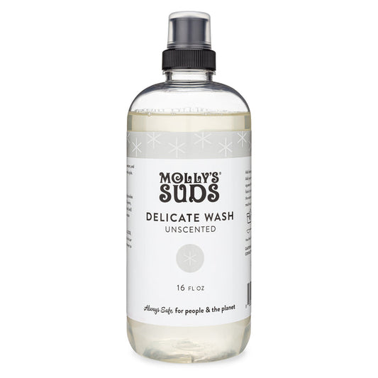 Mollys Suds Delicate Wash, ideal for delicate fabrics, comes in a clear 16 fl oz bottle with a black spray cap. The white label features black text: Delicate Wash Unscented and is adorned with subtle stars and the slogan Always safe for people & the planet, highlighting earth-derived ingredients.
