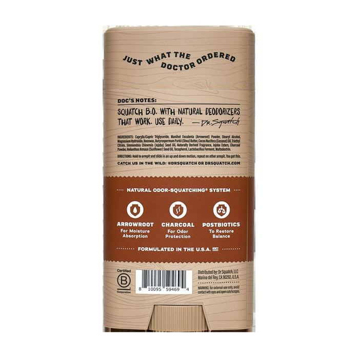 The image shows the back of a Dr. Squatch Deodorant package with a wood texture, detailing natural deodorizers like arrowroot for moisture and charcoal for odor protection, along with skin-nourishing moisturizers and postbiotics for balance.