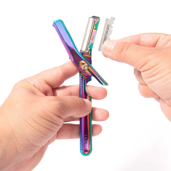 Hands hold a rainbow-textured razor handle from the Dermaplaner Kit by Leaf Shave, designed for exfoliating skin with an open slot for a single-edge dermaplaner blade, ready to be inserted as part of a zero-waste grooming routine.