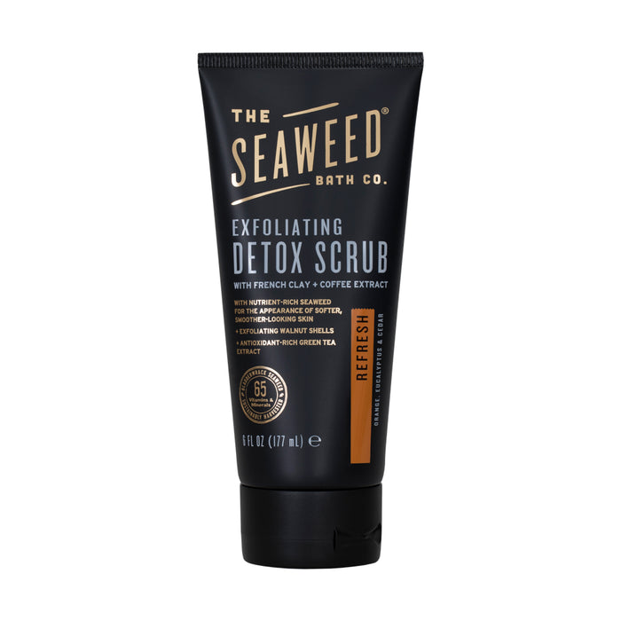 The Seaweed Bath Co Detox Exfoliating Body Scrub in black tube features French clay and coffee extract. Enriched with bladderwrack seaweed, coconut oil, and green tea antioxidants, this 6 fl oz (177 ml) scrub naturally rejuvenates skin.