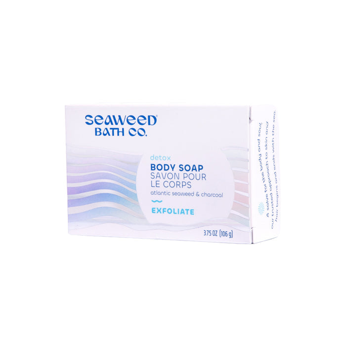 A box of The Seaweed Bath Cos Detox Exfoliating Body Soap showcases a blue and white design, highlighting Atlantic Seaweed & Charcoal for detoxification and featuring Exfoliate in the lower right corner. The weight is 3.75 oz (106 g).
