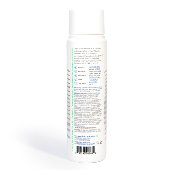 The Seaweed Bath Cos Detox Purifying Body Wash comes in a cylindrical bottle with a white label, showcasing its gluten-free, vegan, and cruelty-free qualities. Its packaged in ocean-bound plastic and includes Bladderwrack Seaweed among its ingredients and contact information.