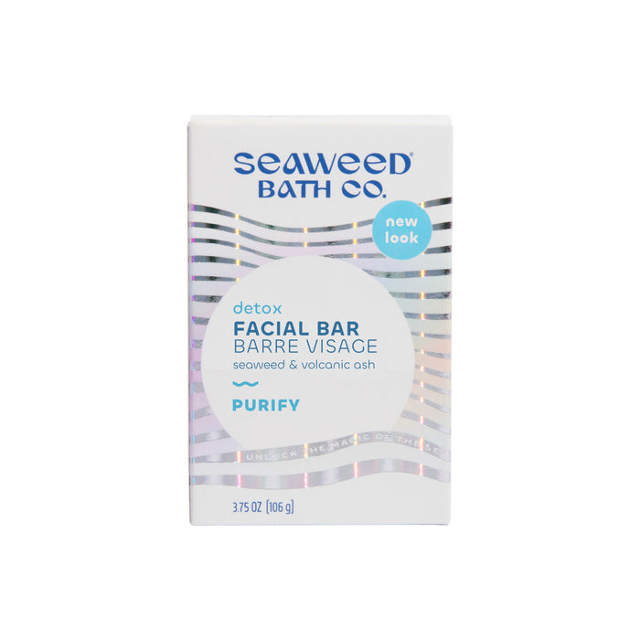 Introducing the Detox Purifying Facial Bar by The Seaweed Bath Co, enriched with bladderwrack seaweed extract and volcanic ash. Its sleek packaging features reflective wavy lines, highlighting its detox and purify benefits, making it perfect for refreshing your skincare routine.