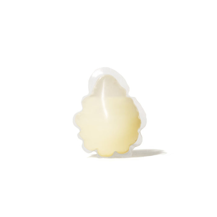 The Dew Bomb Glowy Hydra-Milk Starter Kit by IZZY Zero Waste Beauty features a transparent pouch with scallop edges, holding a pale round patch. Its infused with Glowy Hydrating Milk and a triple-layer hyaluronic acid formula for intense hydration, set against a plain white background.